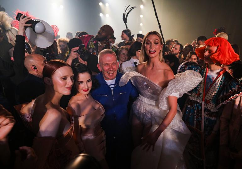 Jean Paul Gaultier, center, at his final show, with Dita Von Teese, left, and Karlie Kloss, right, on Wednesday in Paris at what he said would be his final fashion show.